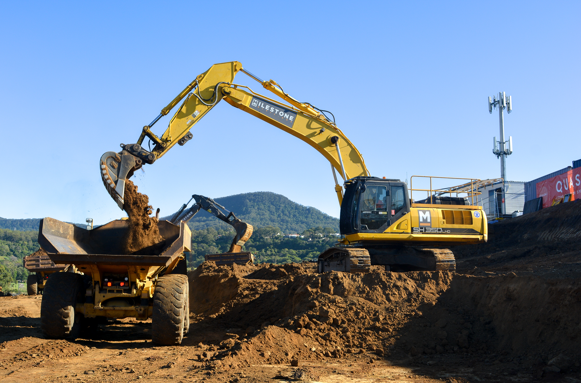 An Excavator Dumping Soil on to a Haul Truck